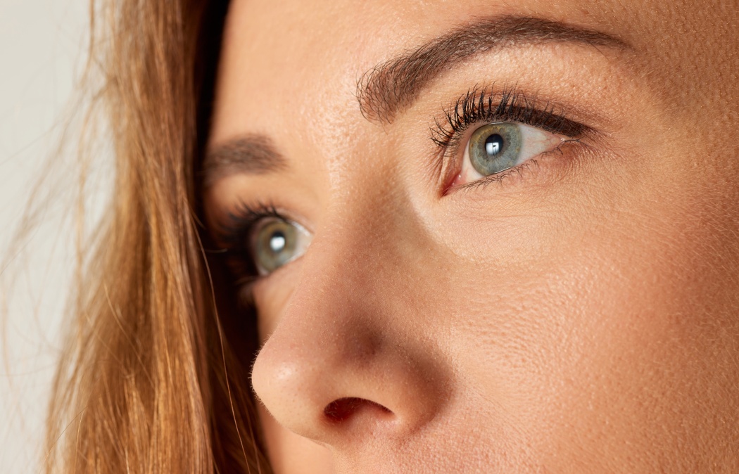 Close-up image of beautiful female face, eyes, brows and nose. Brows and lashes lamination. Concept of natural beauty, skin care, health, plastic surgery, cosmetics, facial treatment, cosmetology